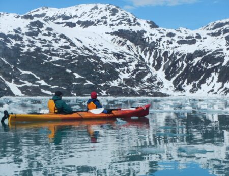 sea kayakers on glassy water during Alaskan cruise