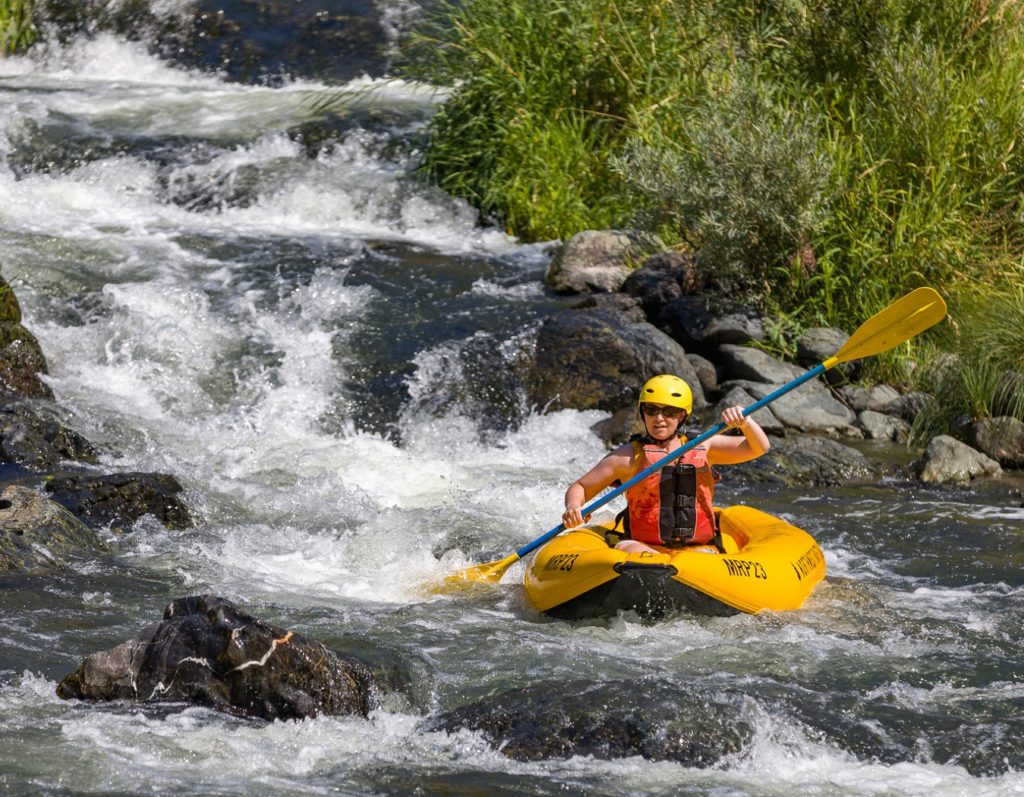 Inflatable kayak running Fish Ladder at Rainie Falls