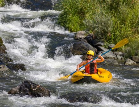 Inflatable kayak running Fish Ladder at Rainie Falls