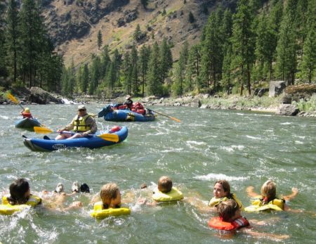 swimmers and rafts floating in the Salmon river
