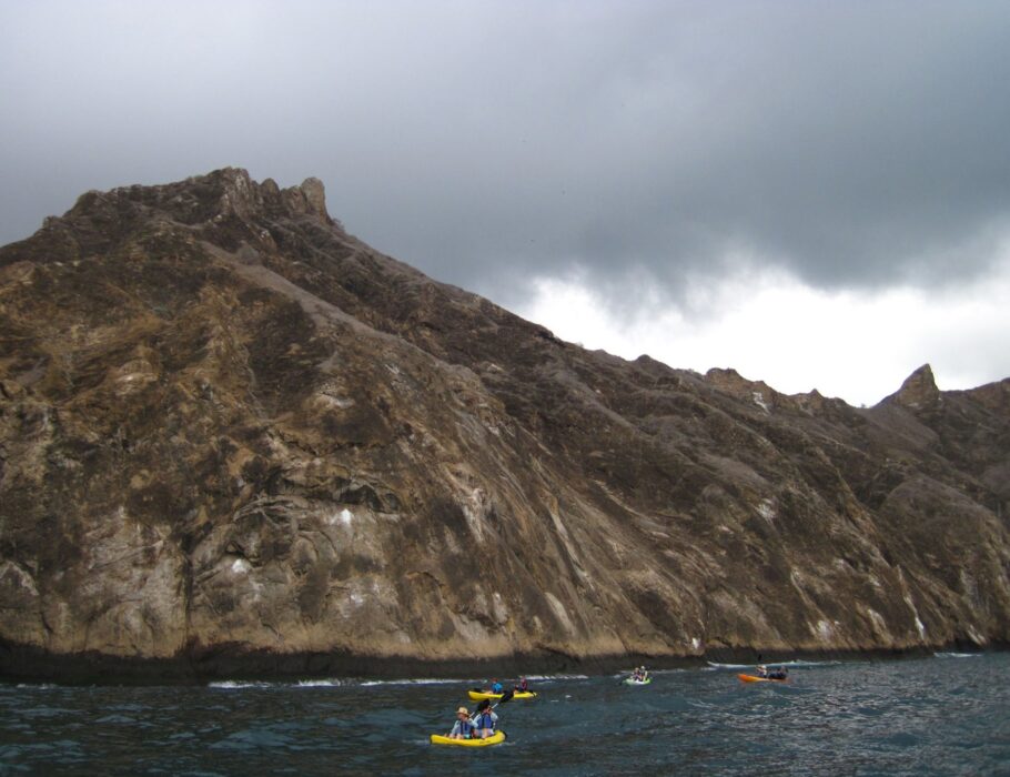 sea kayakers next to Galapagos Island