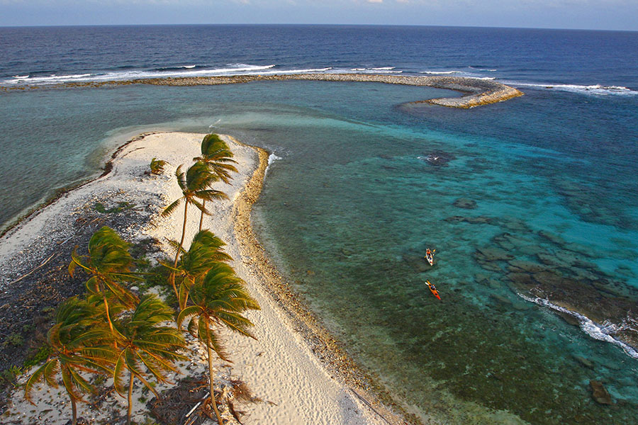 sea kayaks on belizean ocean above coral reefs