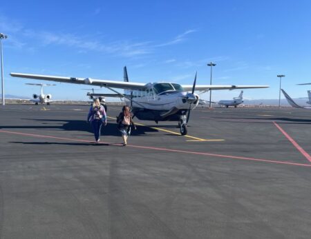 two people getting on plane to go whale watching