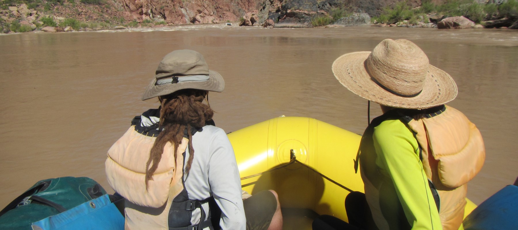 two rafters wearing sun hats and shirts