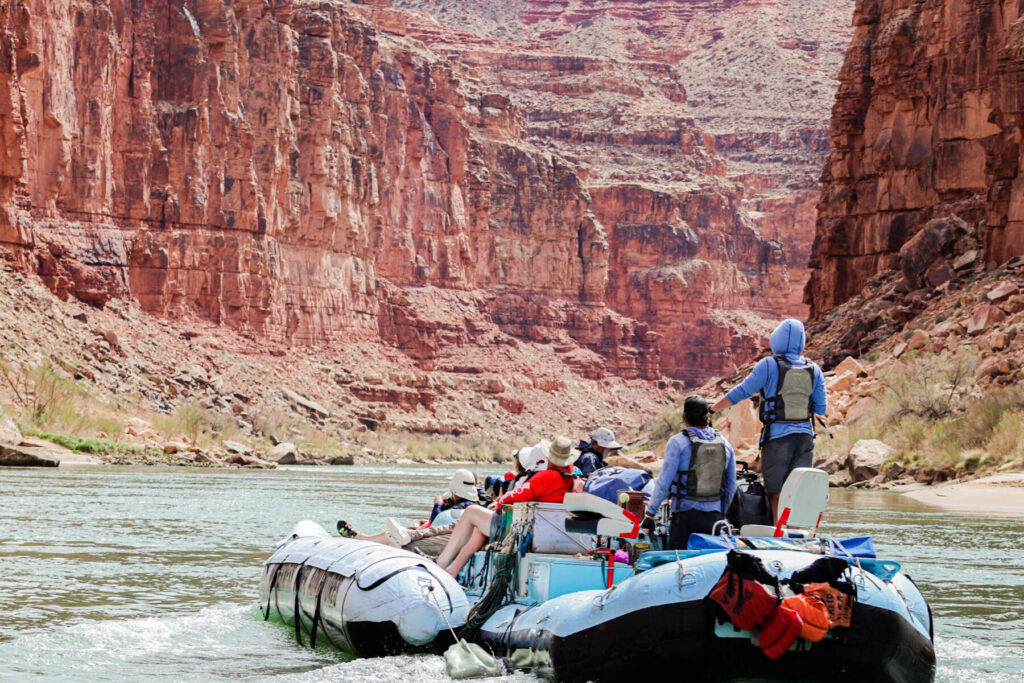 guide wearing sun hoodie in whitewater raft