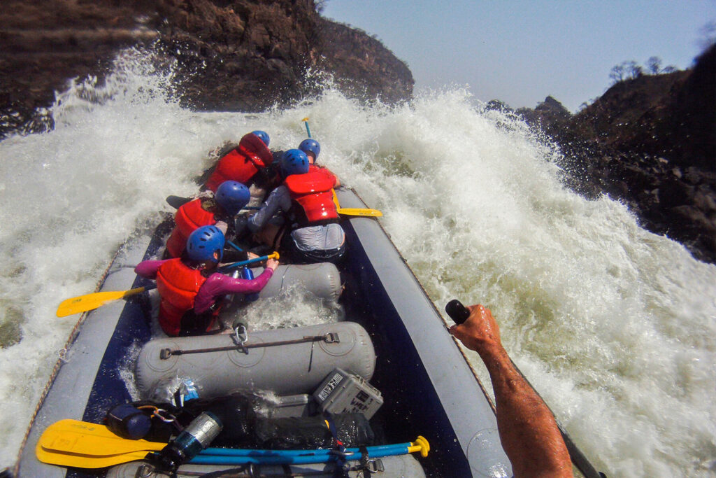 International rafting trip running high volume rapid