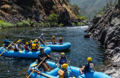3 rafts floating below rapid on the Tuolumne River